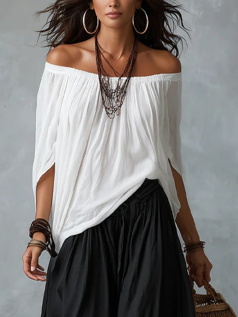 White off-the-shoulder top and flared lantern-style trousers