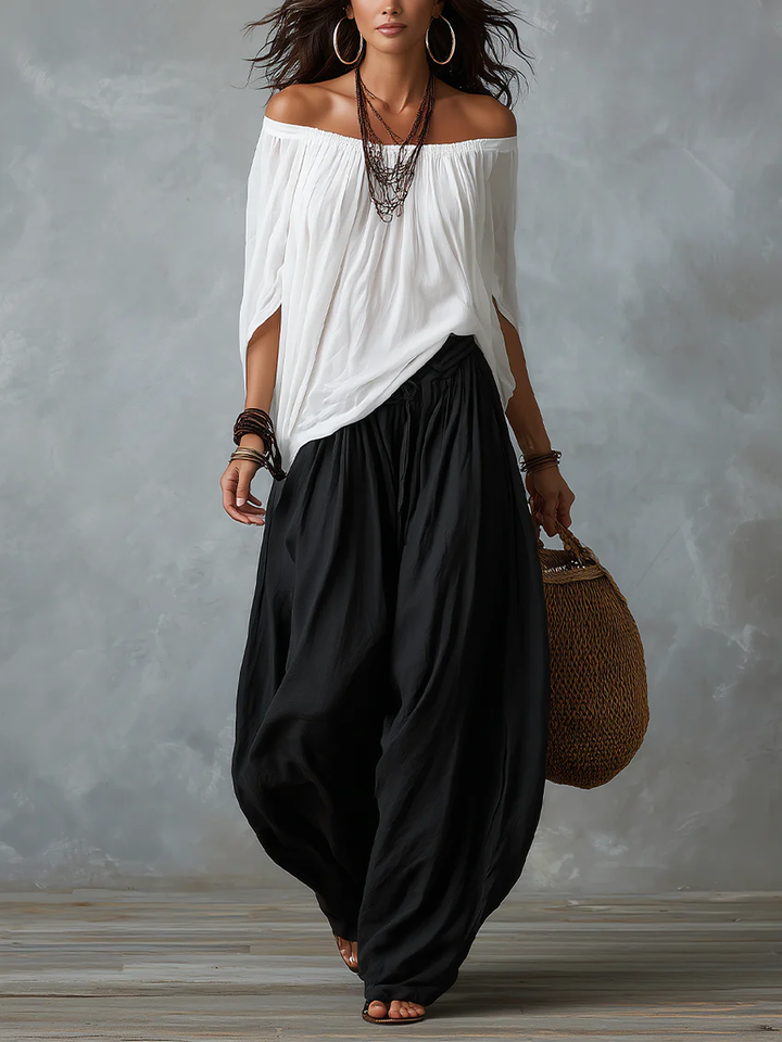 White off-the-shoulder top and flared lantern-style trousers