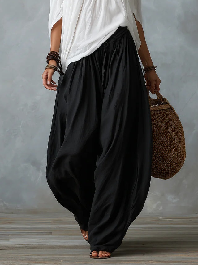 White off-the-shoulder top and flared lantern-style trousers