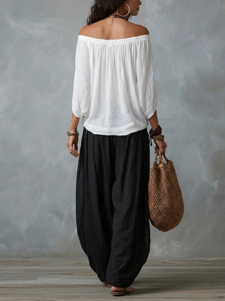 White off-the-shoulder top and flared lantern-style trousers